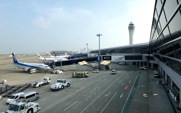 Several airplanes parked at an airport