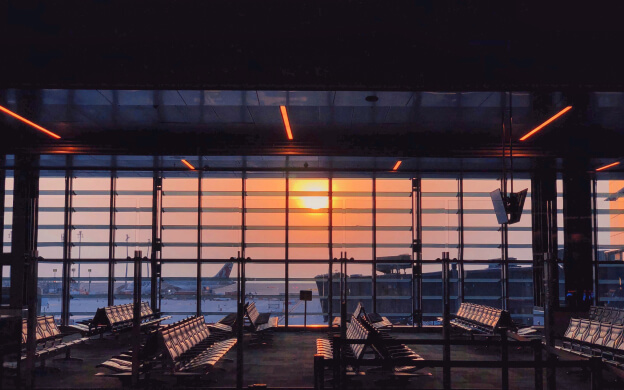 The inside of an airport with the sun low in the sky