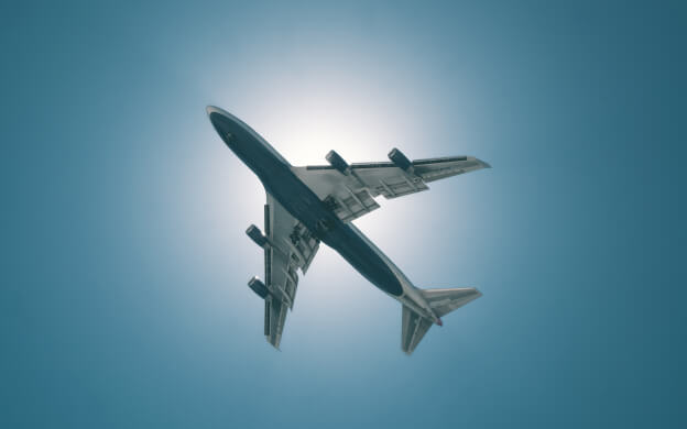 The underside of an airplane in the sky